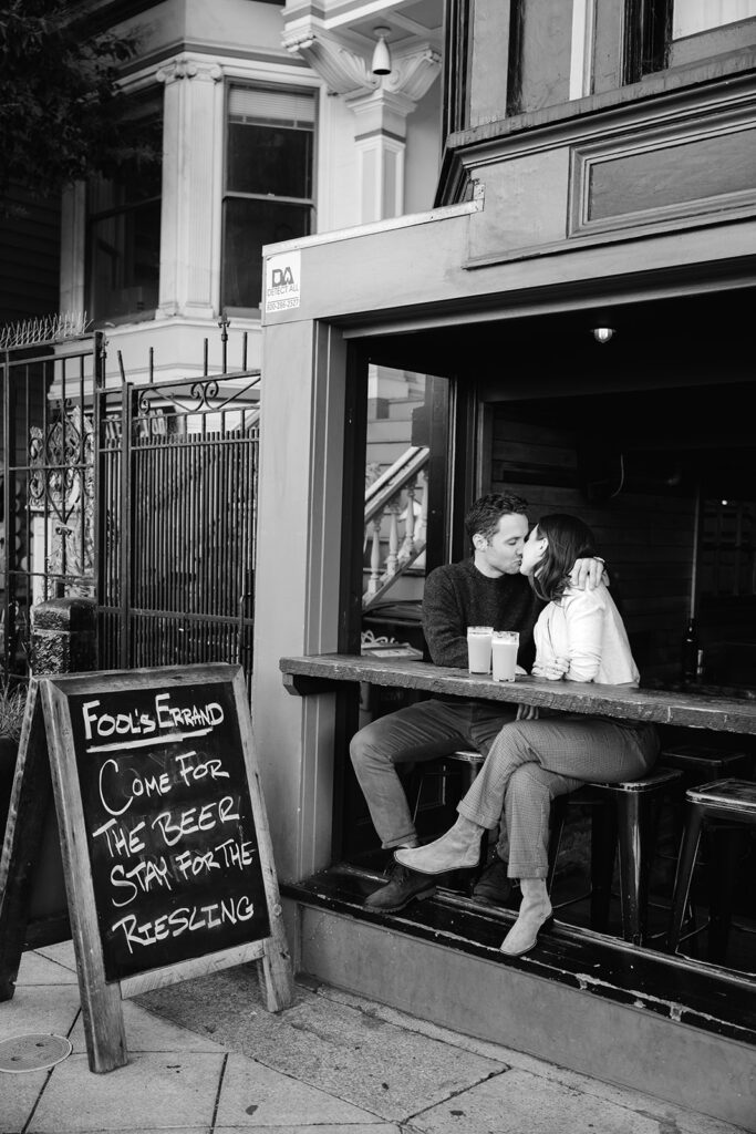 Candid couple kissing at Fool's Errand in San Francisco. 