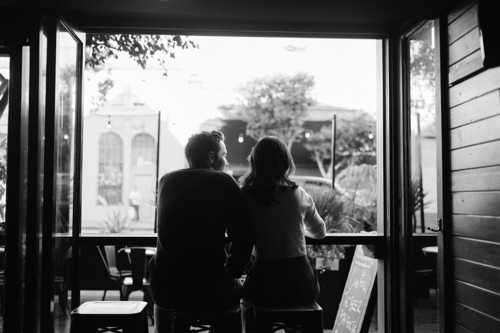Cinematic black and white bar engagement photo in San Francisco. 