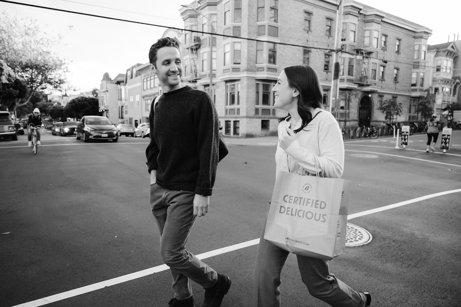 Couple walking with a bag of groceries down the street in San Francisco. 