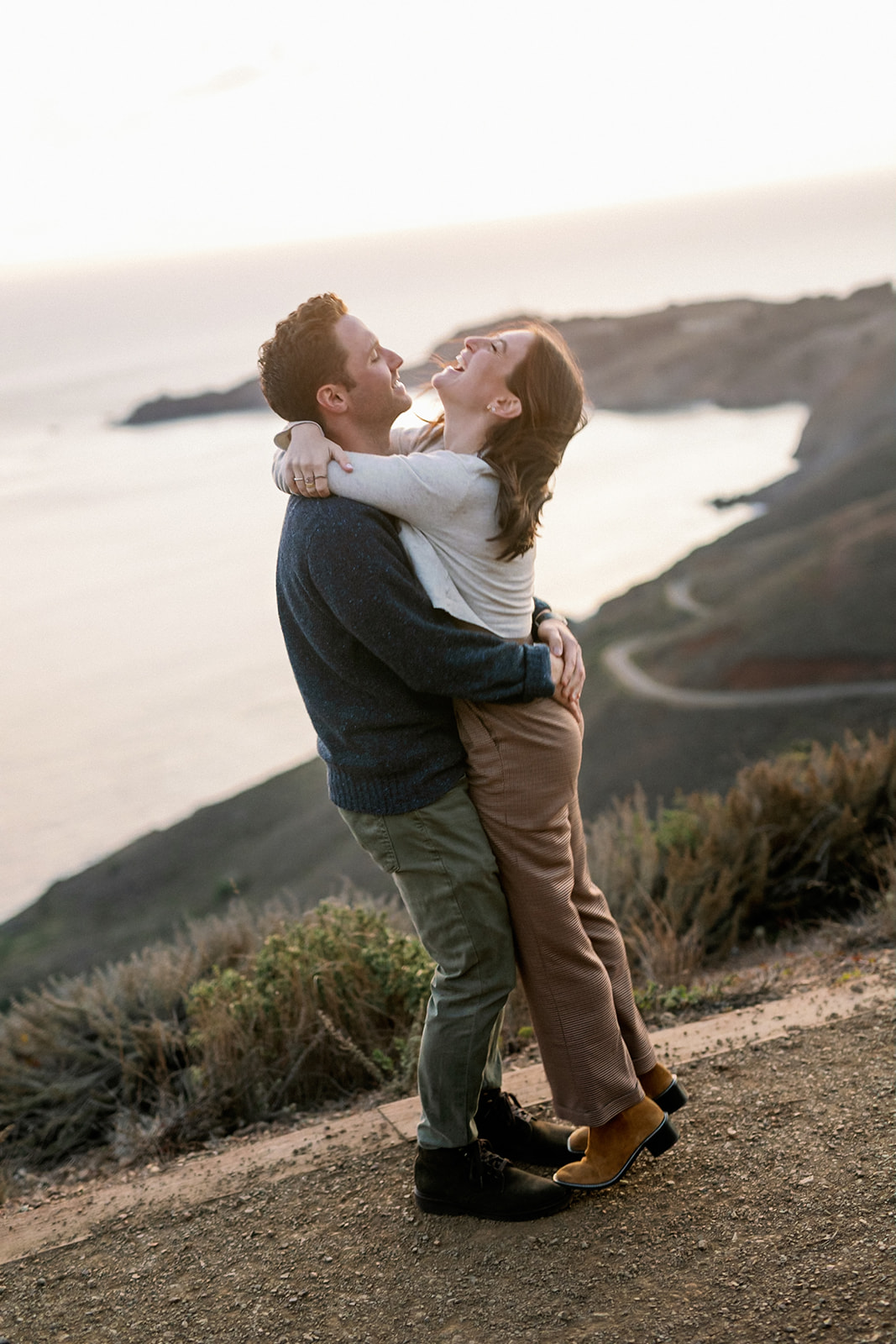 Candid sunset engagement photo at Marin Headlands in San Francisco.