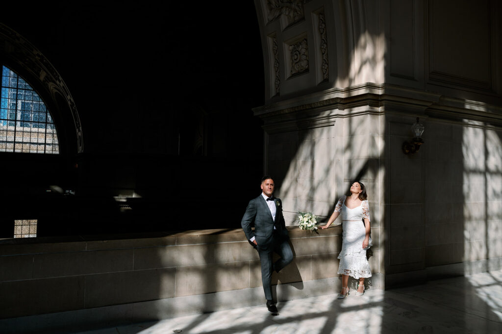 Shadowy artistic bride and groom portrait at SF City Hall. 