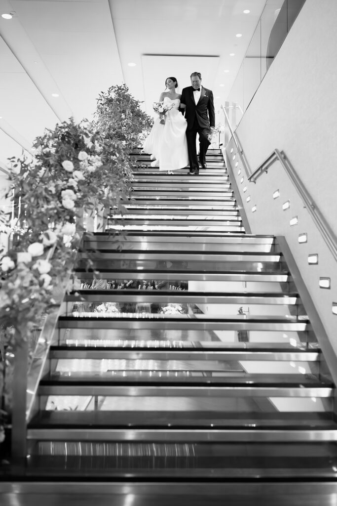 Bride walking down the iconic Boston State Room staircase with her dad. 