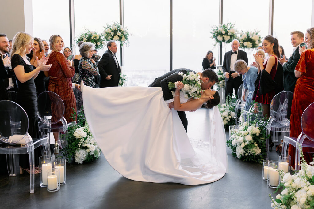 Bride and groom recessional kiss at Boston State Room. 