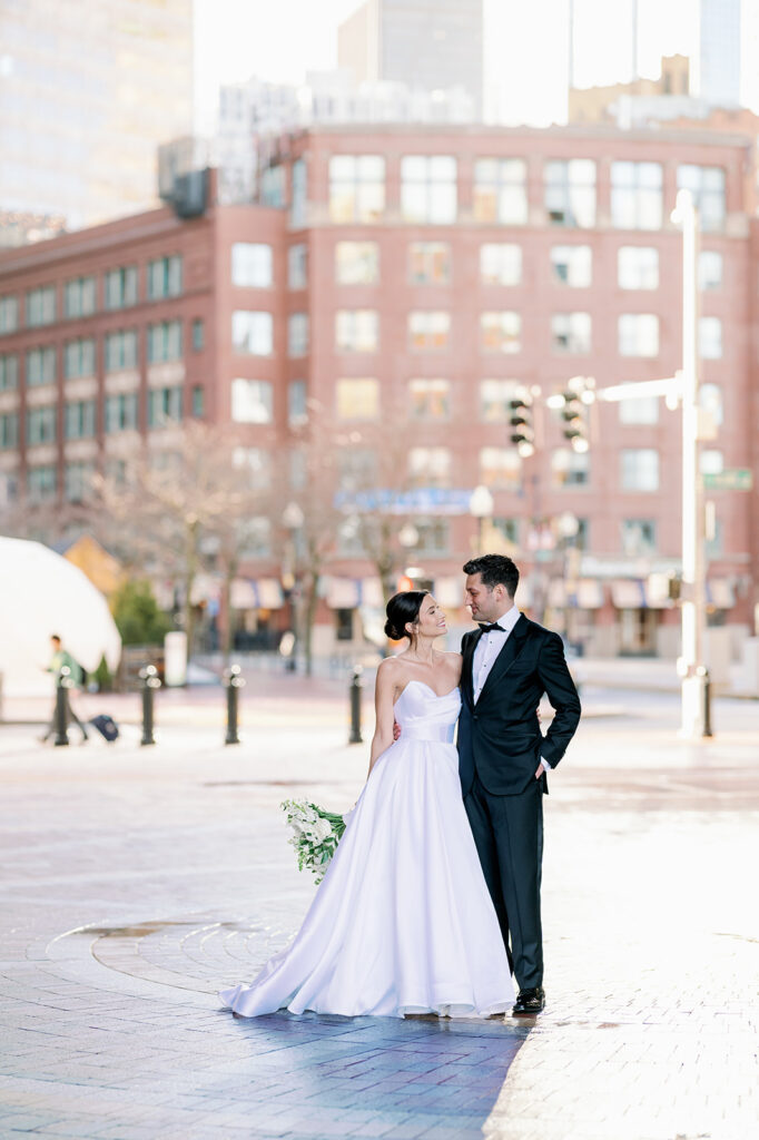 Bride and groom portrait under the iconic arch at Rowes Wharf in Boston.