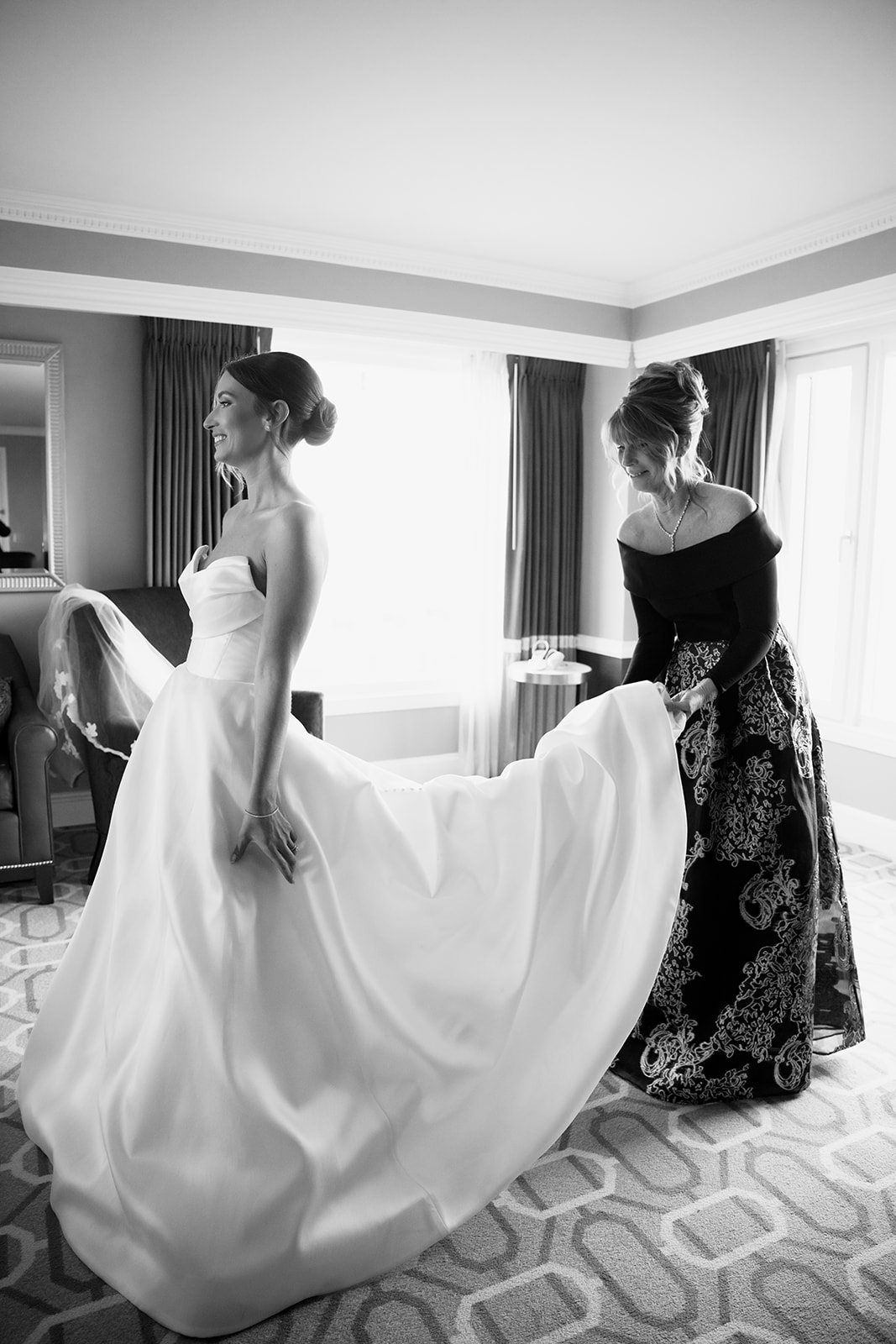 Candid bride getting ready photo with her mom at the Boston Harbor Hotel. 