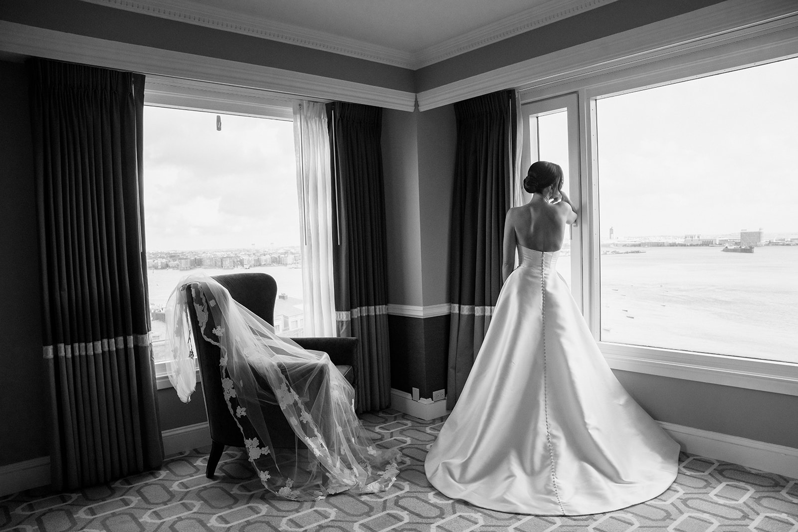 Vogue bridal portrait with panoramic window views at the Boston Harbor Hotel. 