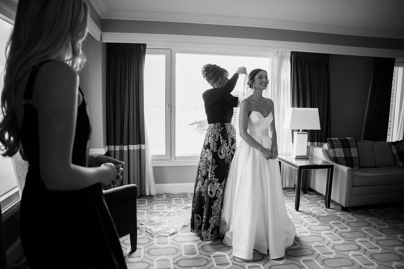 Candid bride getting ready portrait with her mom and sister. 
