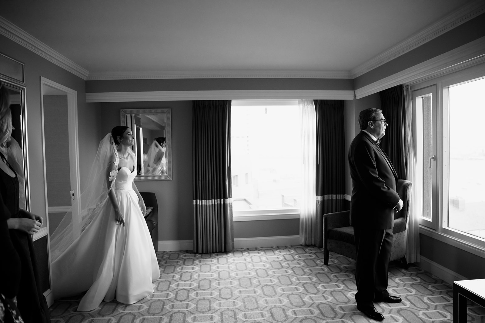 Bride walking towards her dad for a first look at the Boston Harbor Hotel. 