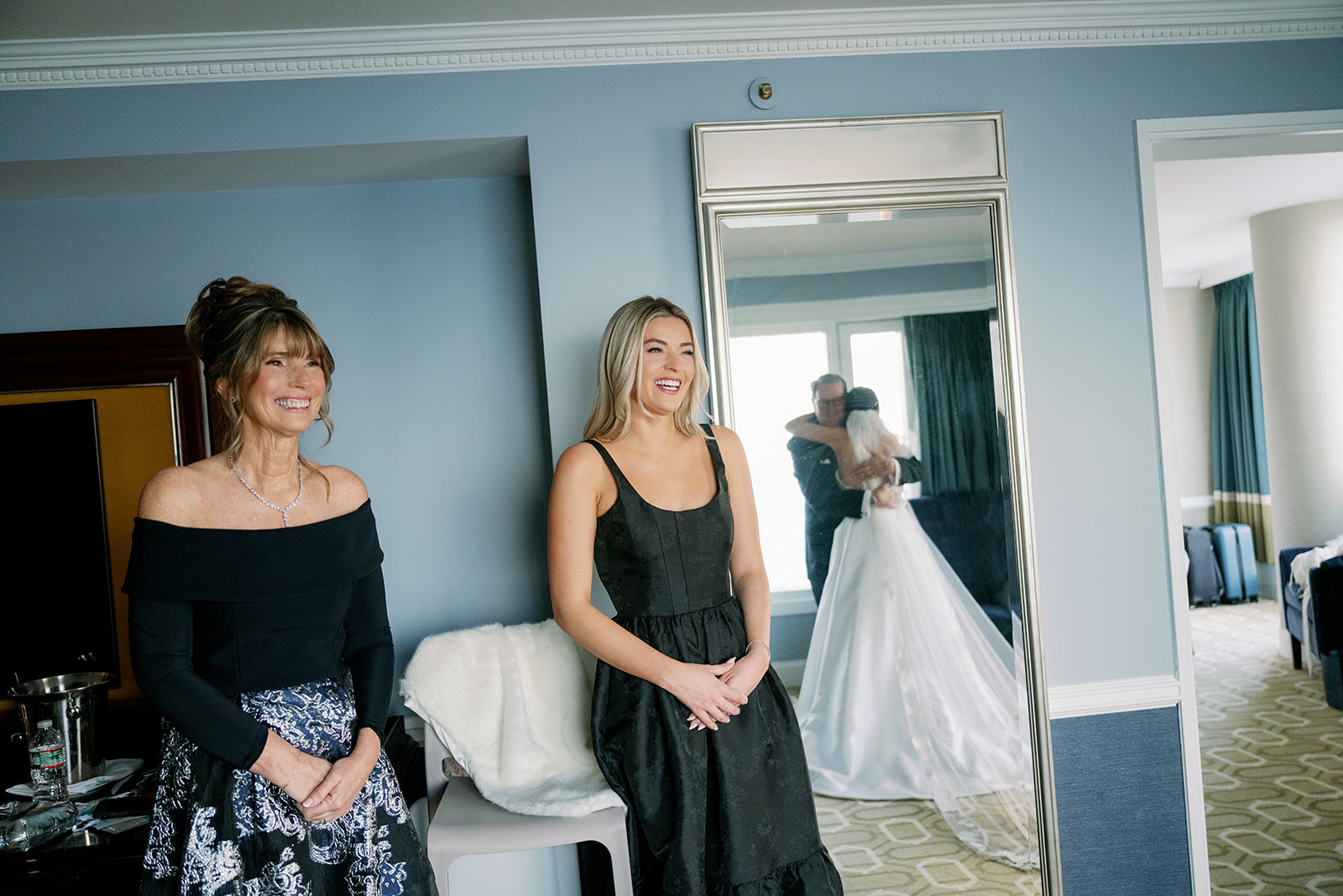 Candid reactions from the bride's mom and sister during the father-daughter first look. 