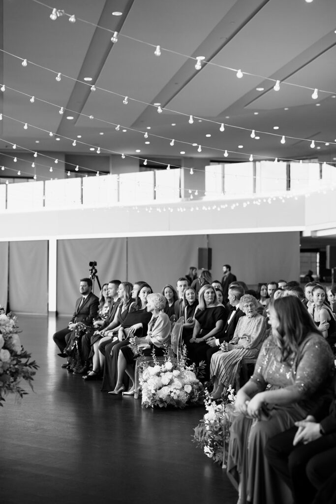 Black and white wide-angle view of wedding ceremony guests at a Boston State Room wedding.