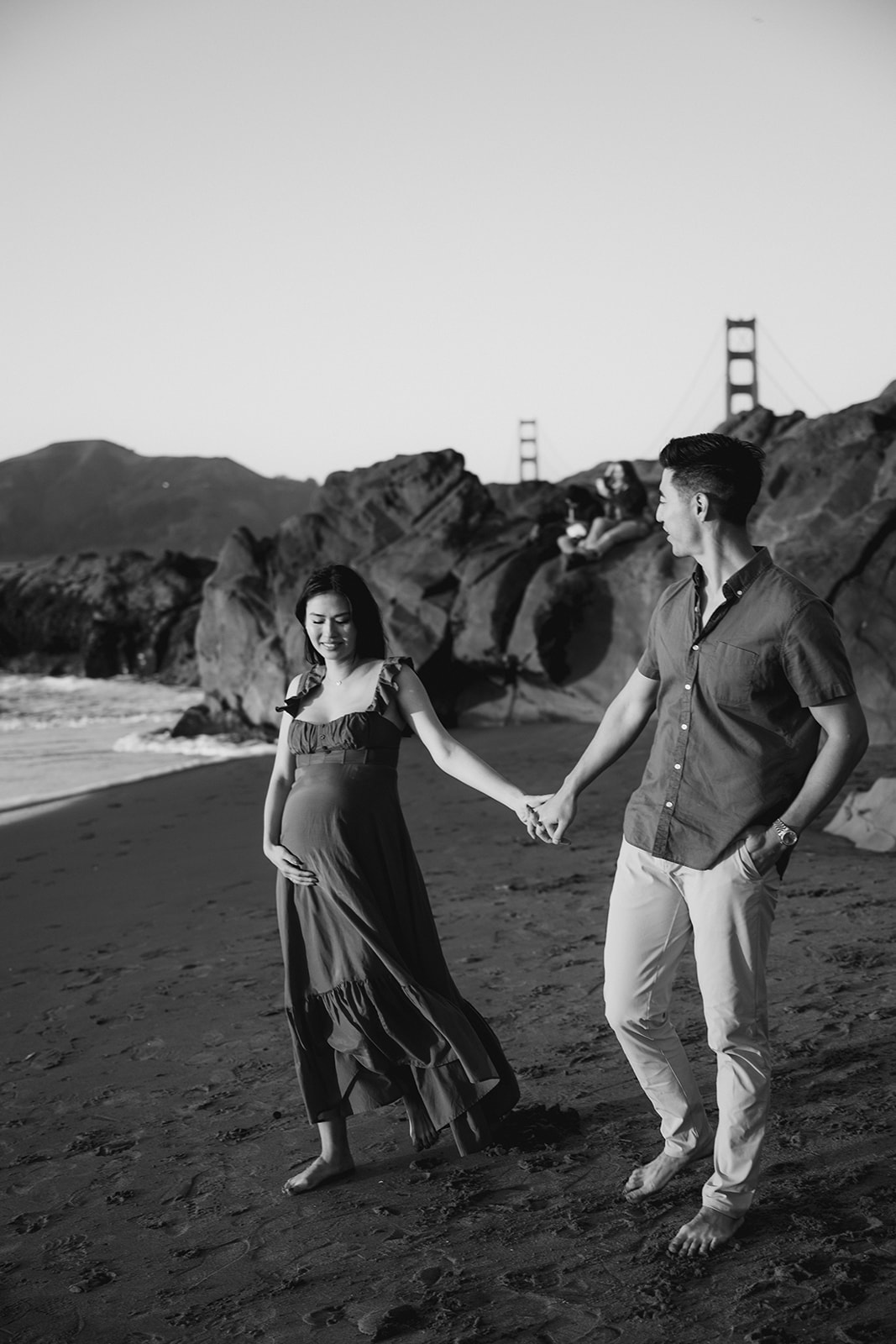 Baker Beach sunset engagement photoshoot in San Francisco with the Golden Gate Bridge in the background. 