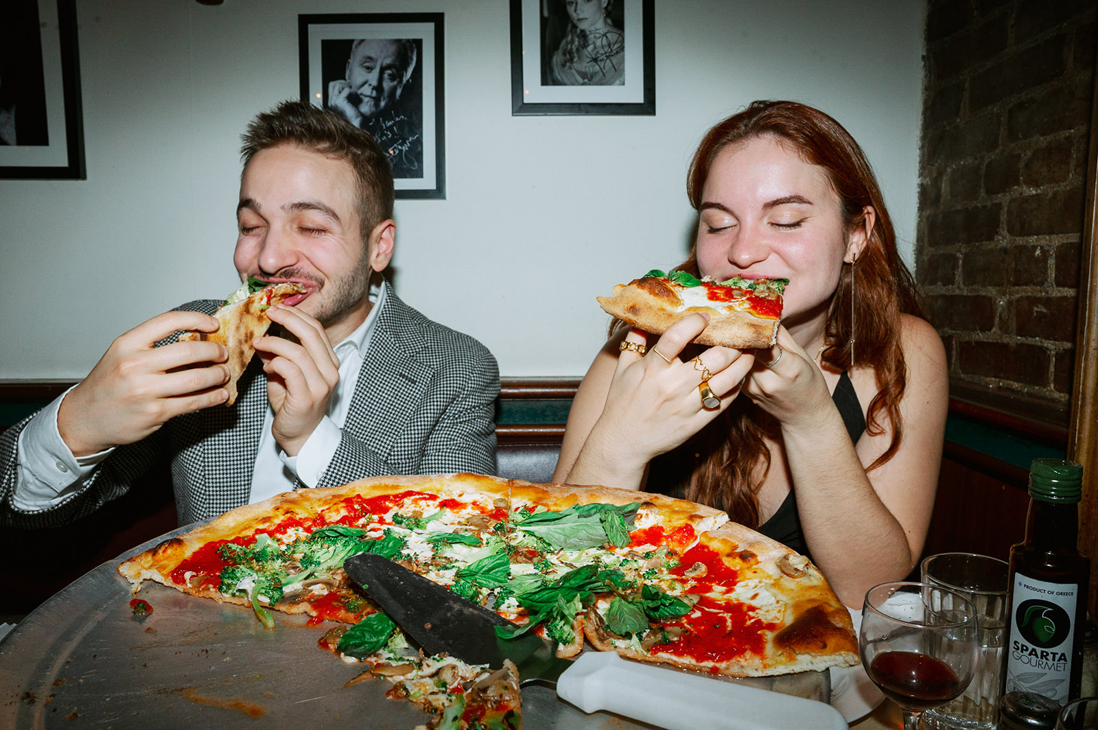 Couple eating pizza in downtown San Francisco for their engagement photoshoot. 